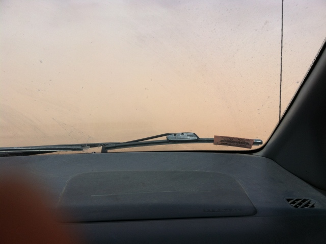 It's impossible to really capture, but this is the view from the windshield. It was a sunny day so it should show a road and some giant rock formations ahead of us. Instead, just dust.